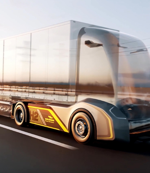 Futuristic truck with a transparent cockpit, driving on a road