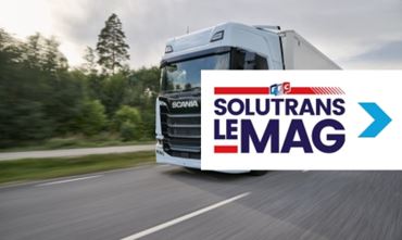 image of blue globetrotter truck driving fast on a concrete road with SOLUTRANS emag logo